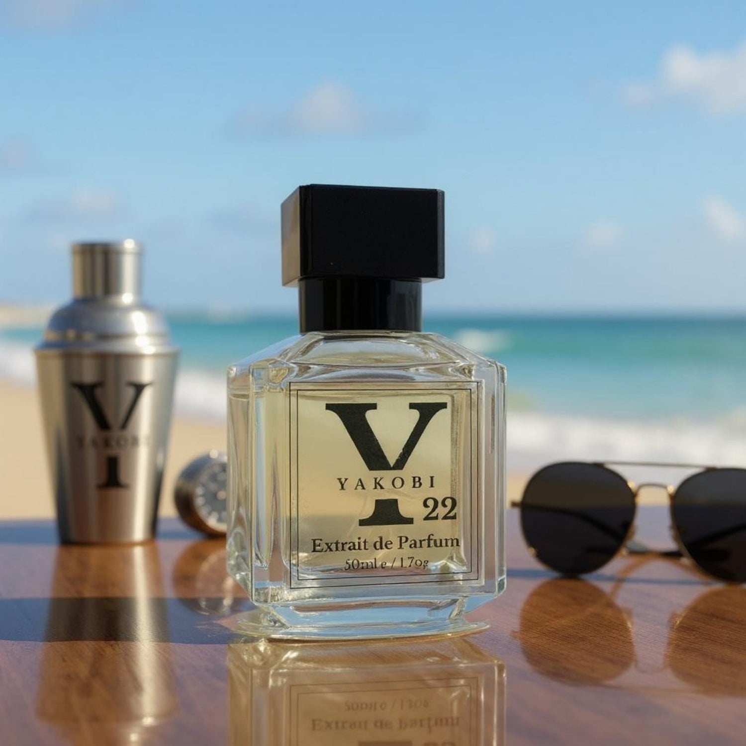 Yakobi Y22 Extrait de Parfum 50ml on a wooden surface by the beach, with sunglasses and ocean waves in the background, evoking a bold summer vibe.